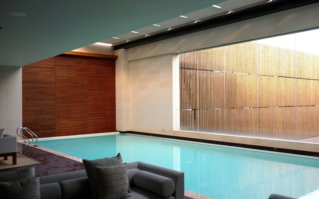 two gray sofas beside pool in room